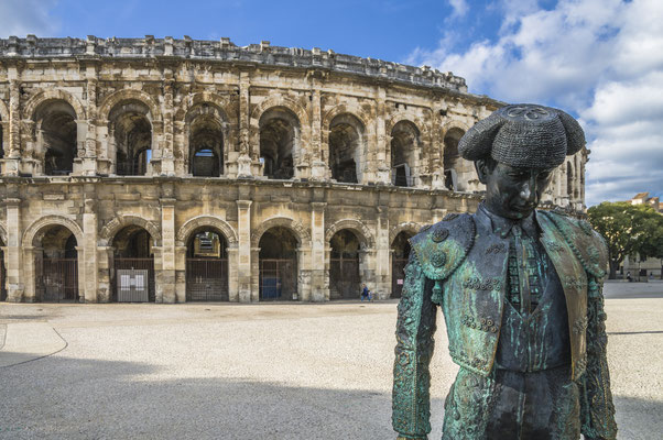 Roman Arena (Amphitheater) in Arles and bullfighter sculpture, Provence, France - Copyright Emanuele Mazzoni Photo